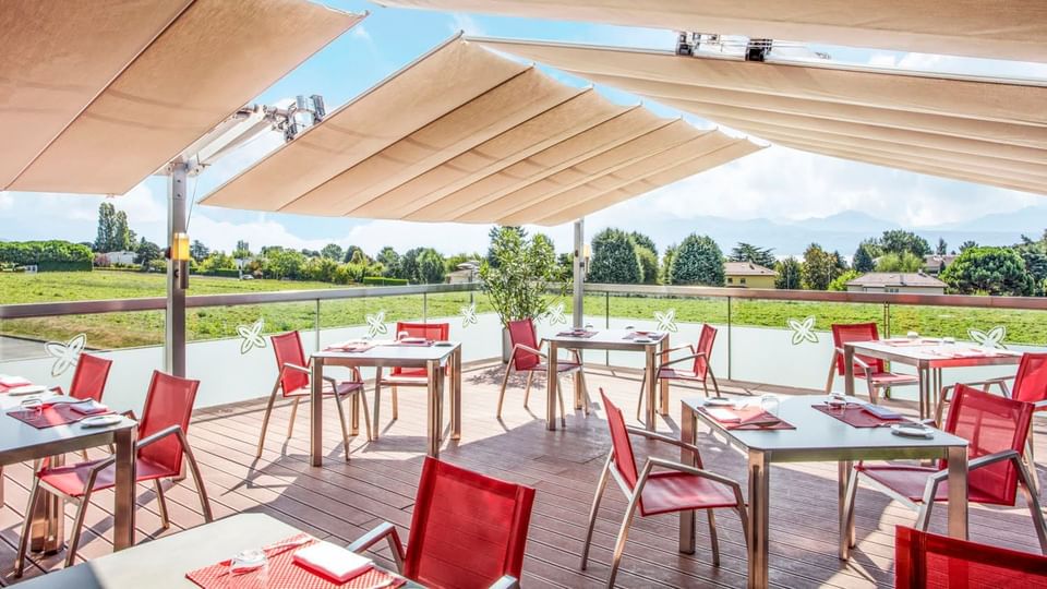 Outdoor dining area with a scenic view in the background at Starling Hotel Lausanne