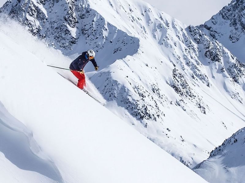 Skier skiing in a mountain near Falkensteiner Hotels