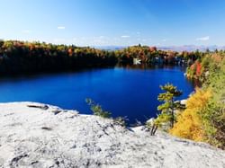 Bright blue lake surrounded by fall trees