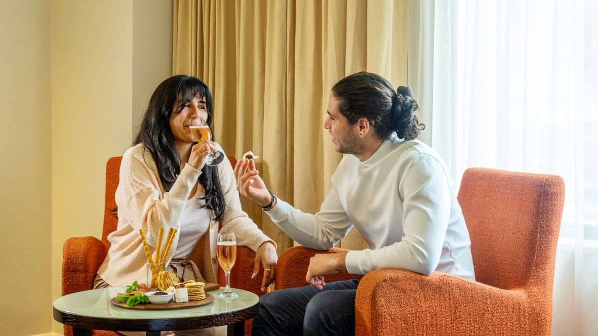 Couple enjoying drinks and snacks on Valentine's Day.