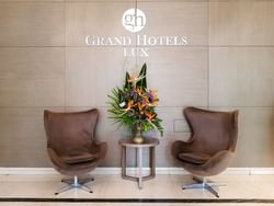 Lobby lounge area by a Hotel sign at Grand Hotels Lux