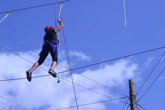 Woman engaged in high rope course near Honor’s Haven Retreat