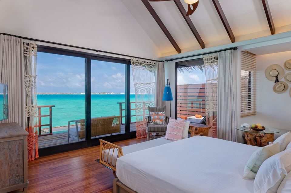 Comfy bed, and loungers in a room overlooking the sea at Grand Park Kodhipparu