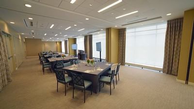 a spacious event room with tables and chairs