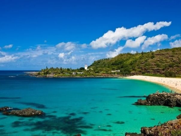 Distant view of Waimea Bay on a sunny day near Paradise Bay Resort