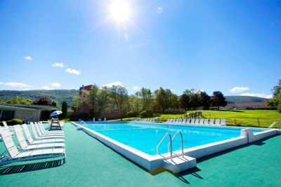 Pool area with sun loungers at at Honor’s Haven Retreat