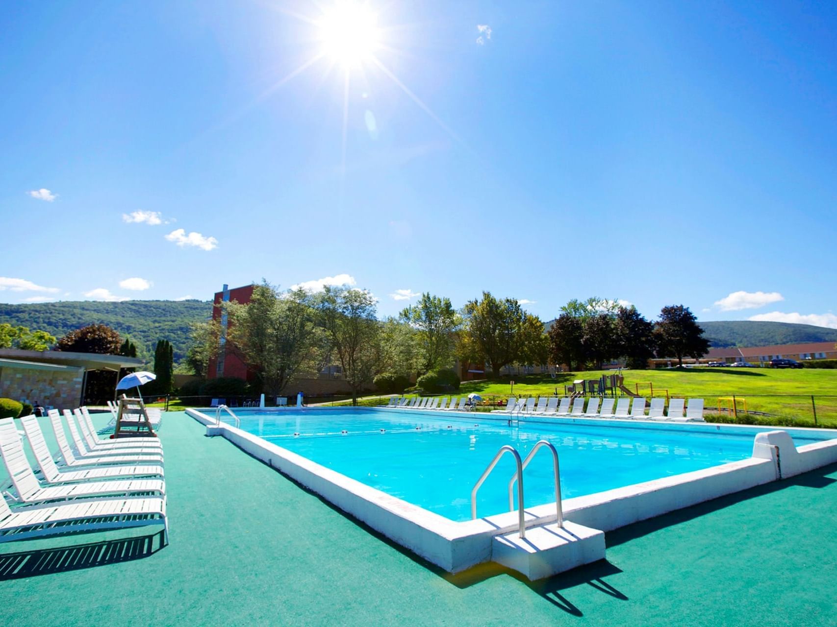 Pool area with sun loungers at at Honor’s Haven