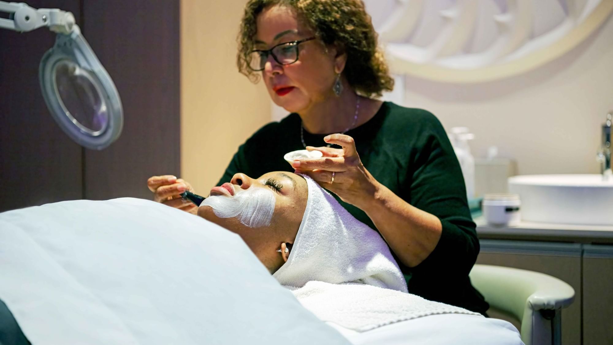 Lady having a facial in The Diplomat Spa at Diplomat Beach Resort