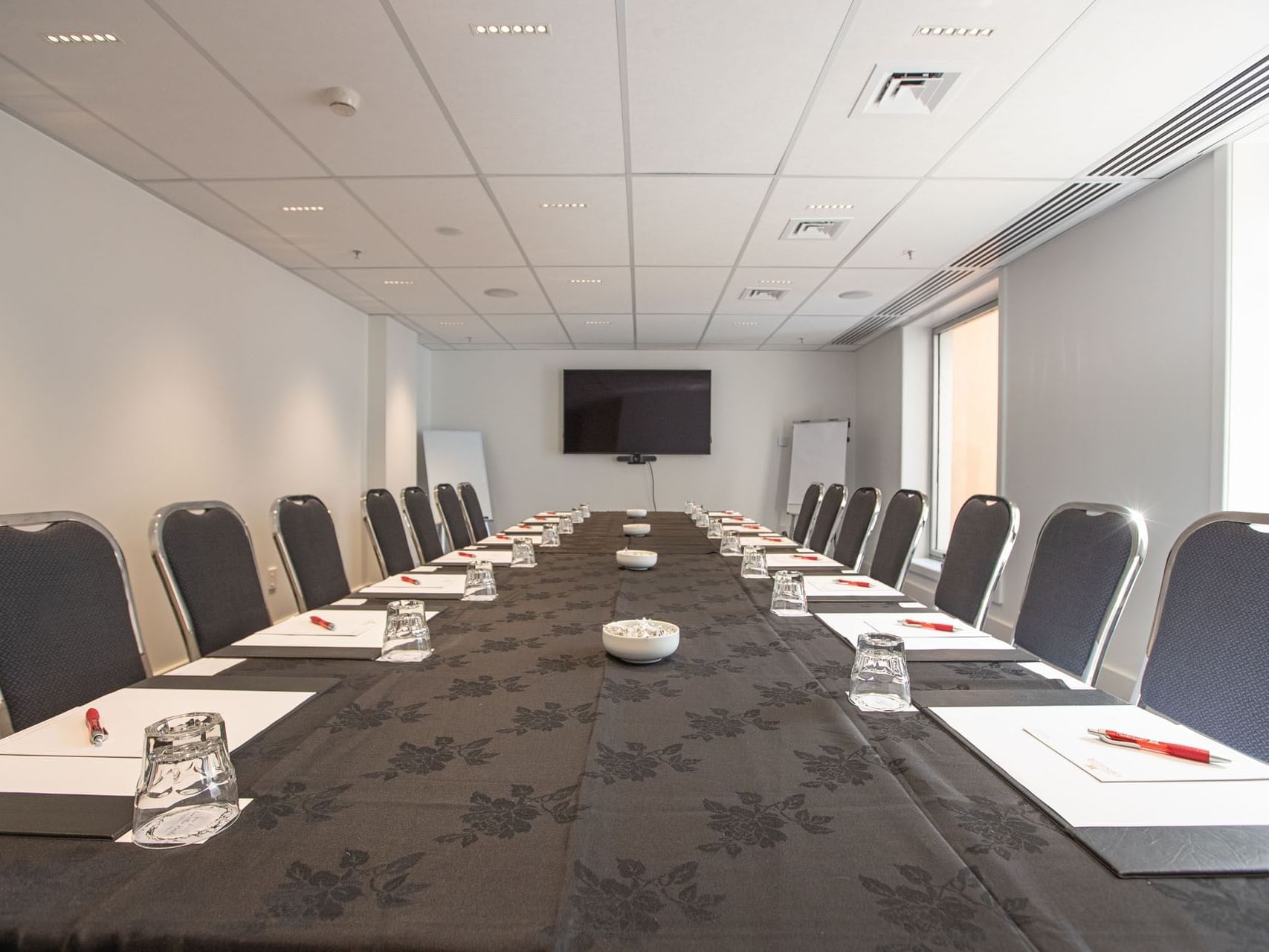 Conference set-up with stationaries in Boardroom 3 at James Cook Grand Chancellor