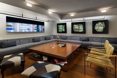 Lounge with a large coffee table & couch at The J House Greenwich, a boutique hotel in Greenwich for events and meetings