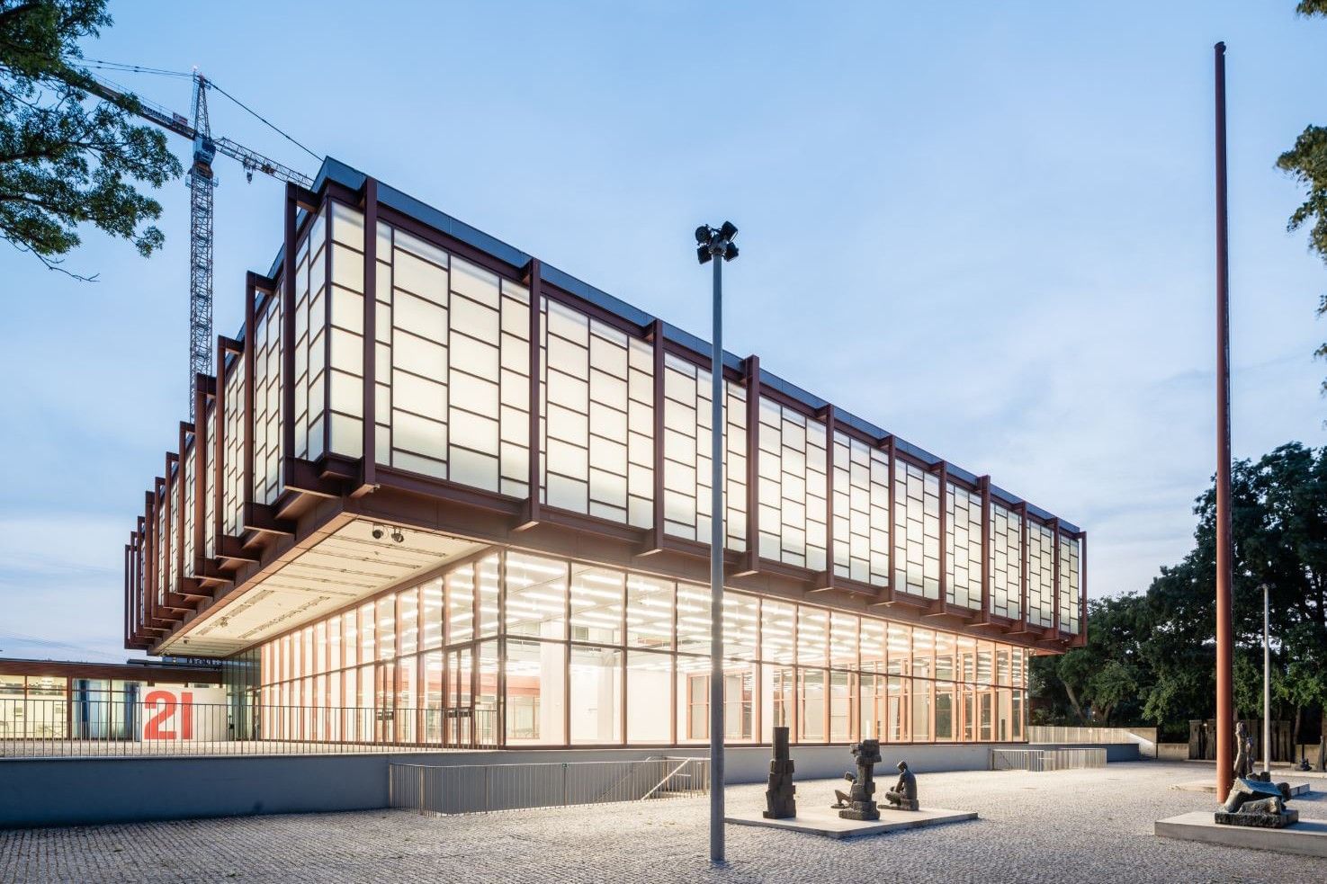 Historic exterior view of Albertina modern in Vienna featuring neoclassical architecture, columns, and sculptures at the museum entrance