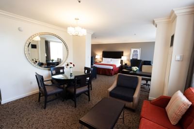 furniture in hotel suite with bed in background