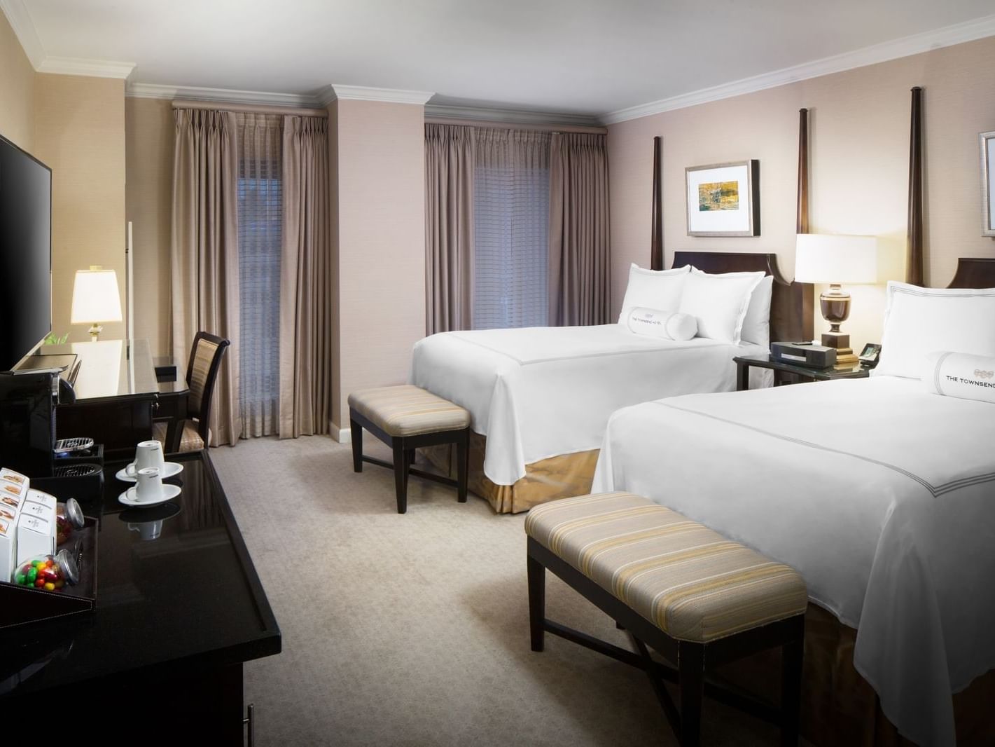 hotel room with two beds and a tv