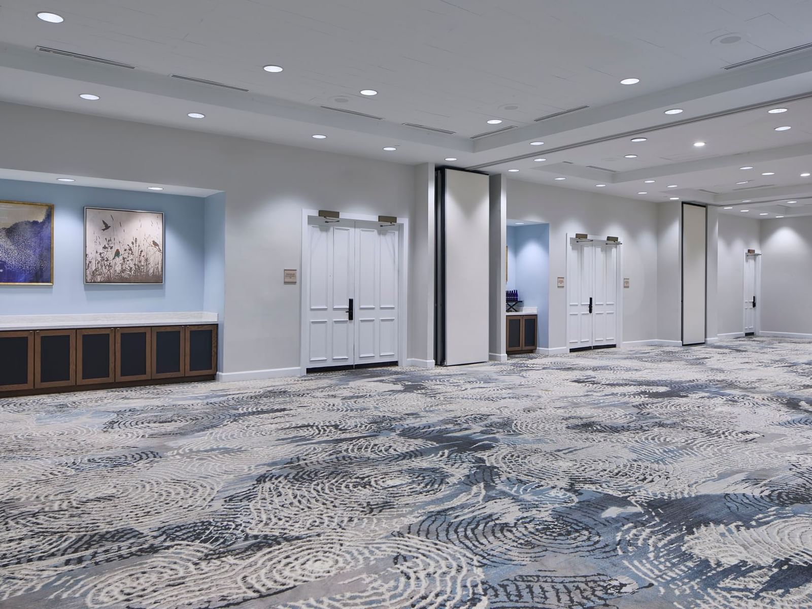 Orlando meeting venues of Sabal Two with blue swirling carpet, showing multiple entry doors & art at the Inn at Celebration