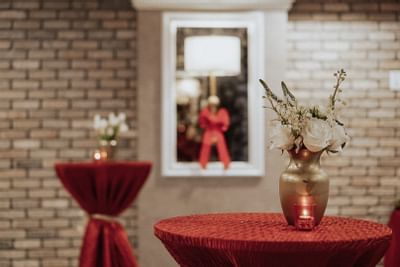 brick room with red cocktail tables
