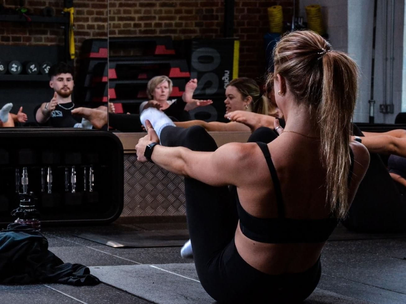 Close-up of a lady from a group doing Yoga at East Park Gym