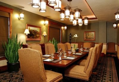 Large wooden table with chairs by the window and carpet floors in Board Room at Hotel Park City Autograph Collection 