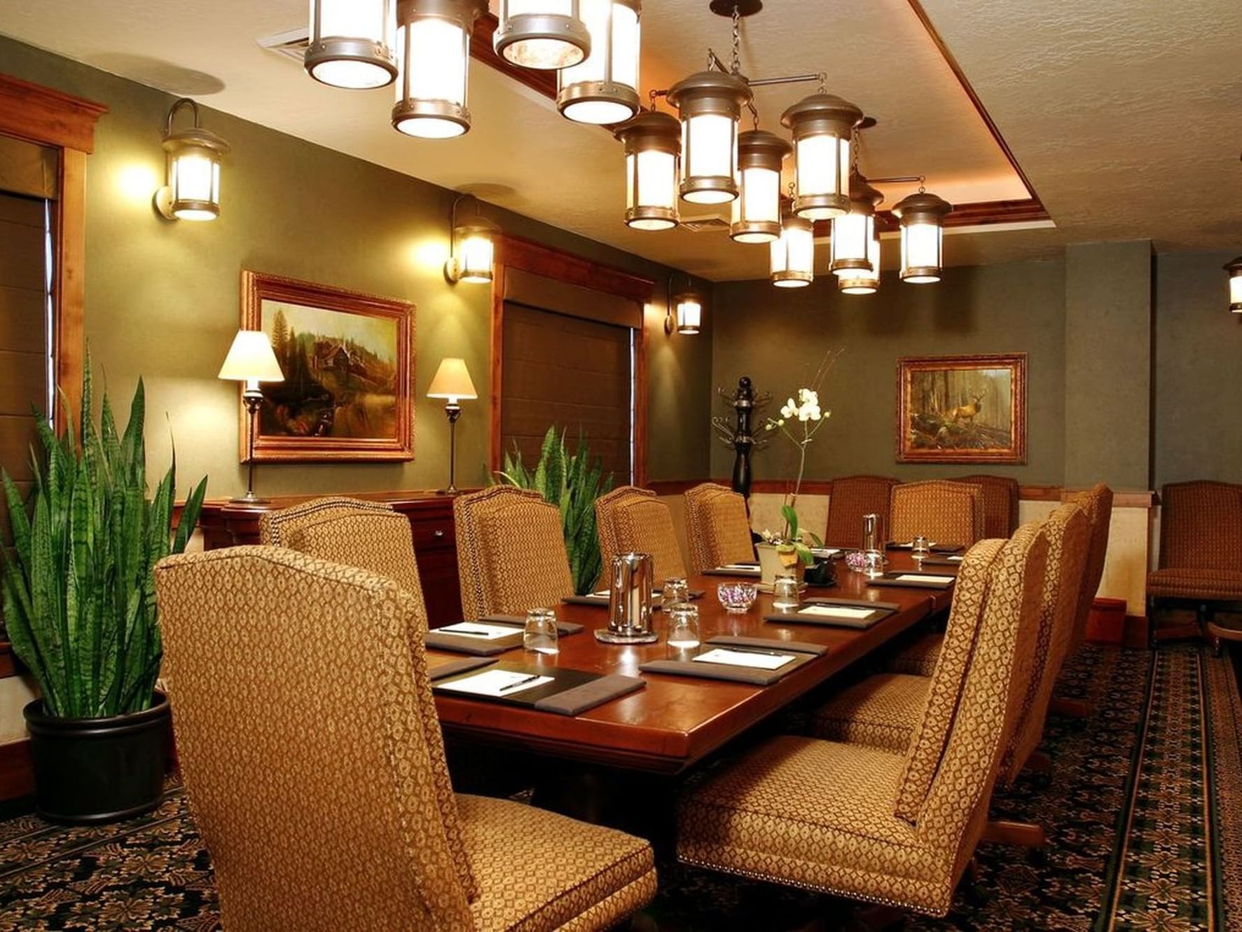 Large wooden table with chairs by the window and carpet floors in Board Room at Hotel Park City Autograph Collection 