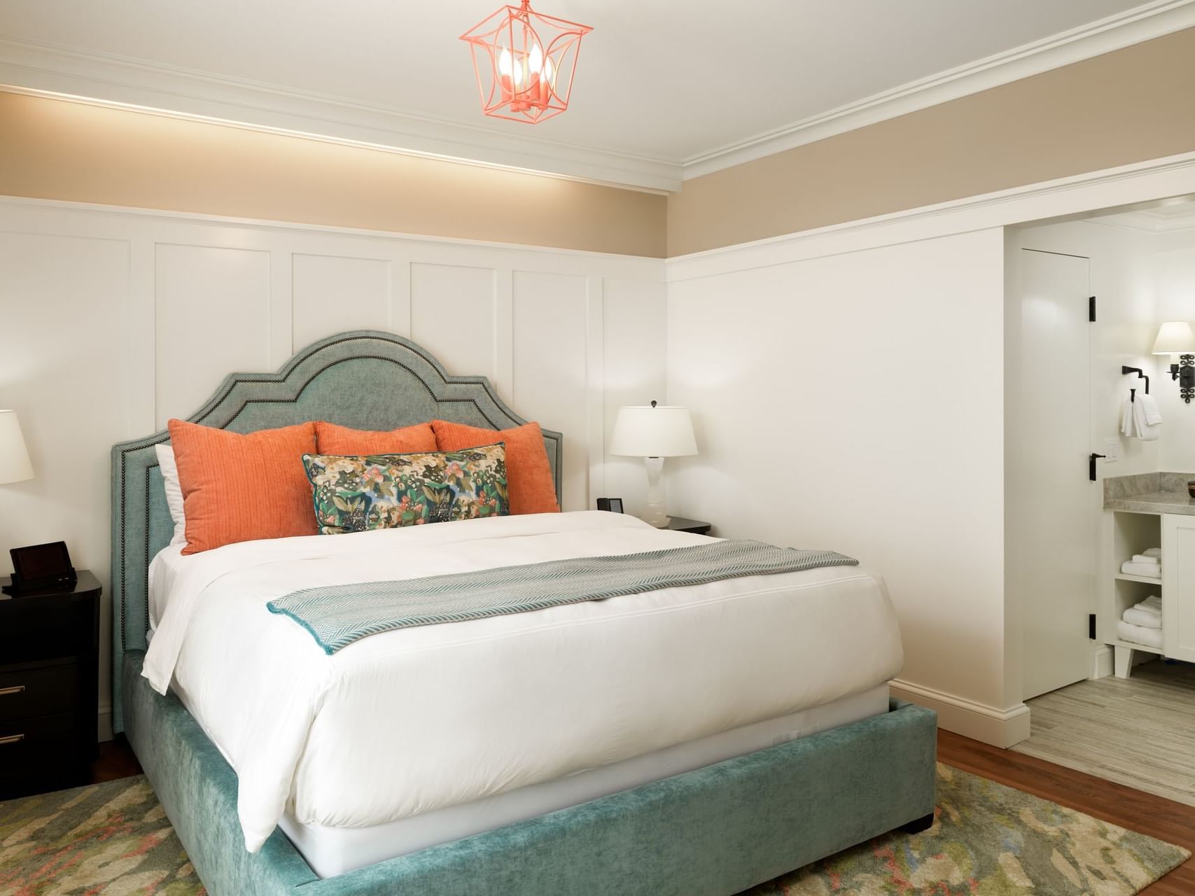 Bathroom vanity by the bedroom with queen bed in Ada Elizabeth Suite at Hotel Atwater