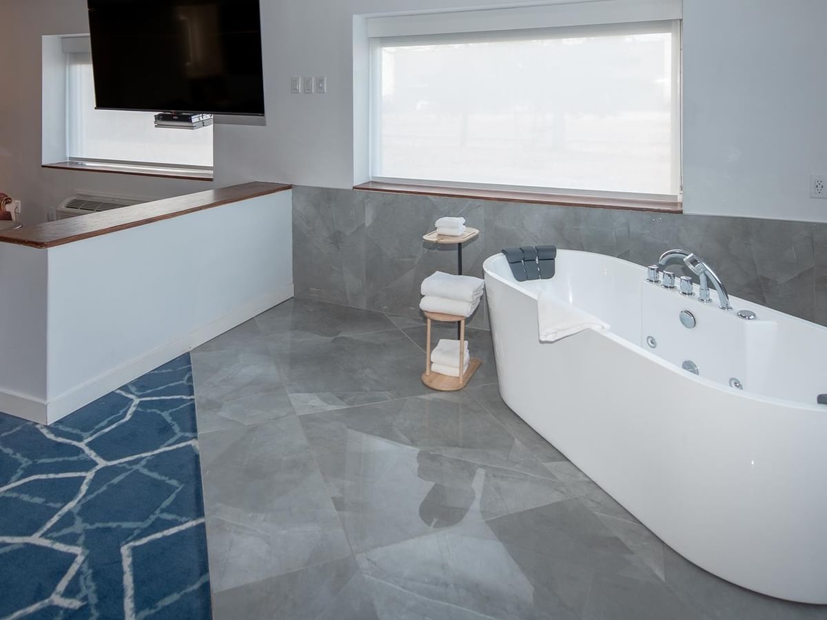 Spacious suite with jetted tub and TV.