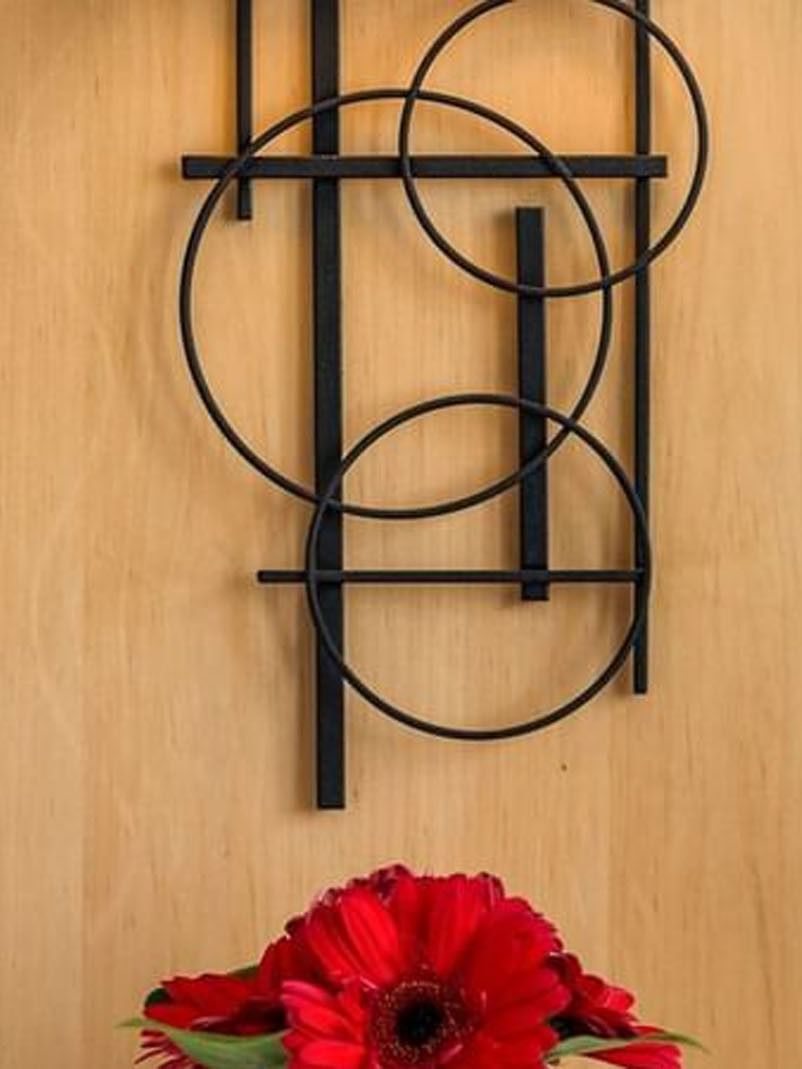 Abstract black wire circles by a red flower under a wooden headboard in Deluxe Room at Warwick Seattle