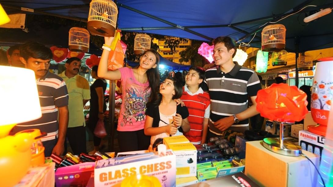 A Family choosing items at a brightly lit night market stall near Sunway Hotel Big Box