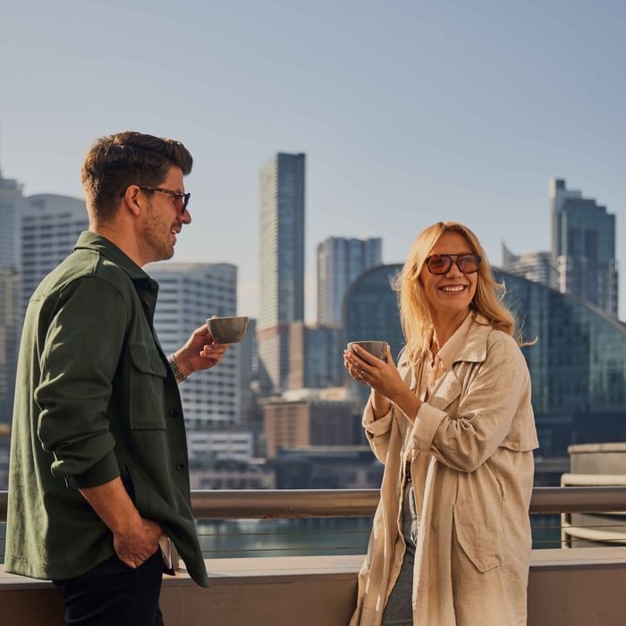 Couple enjoying sunset drinks on ibis bar deck
