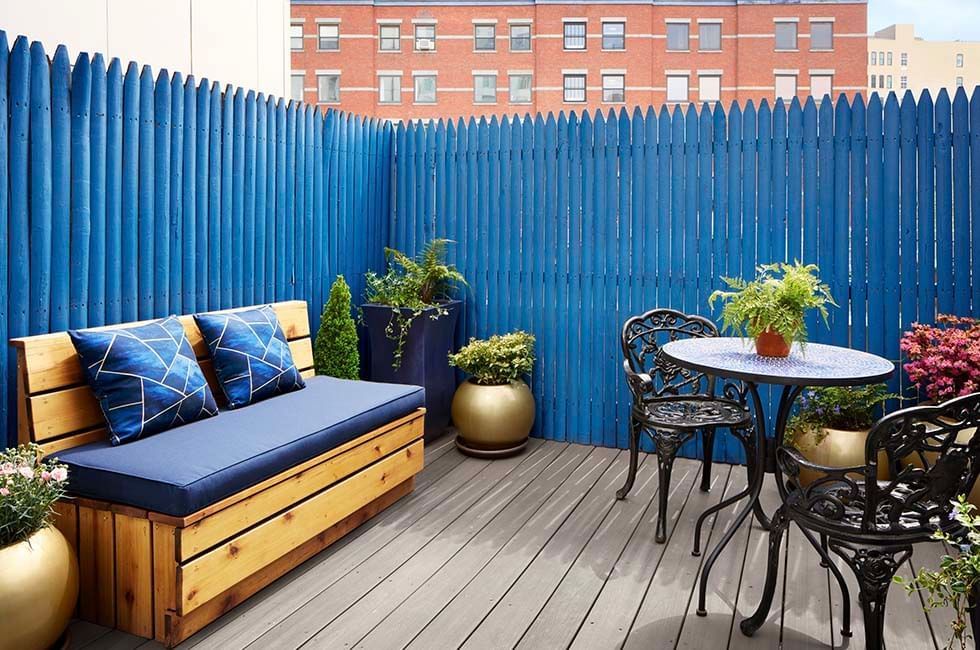 Gansevoort patio terrace with a sofa, plants and dining chairs