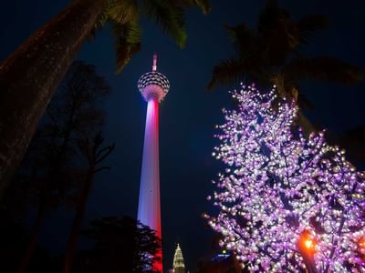 low-angle view of Kuala Lumpur Tower at nighttime near Sunway Velocity Hotel