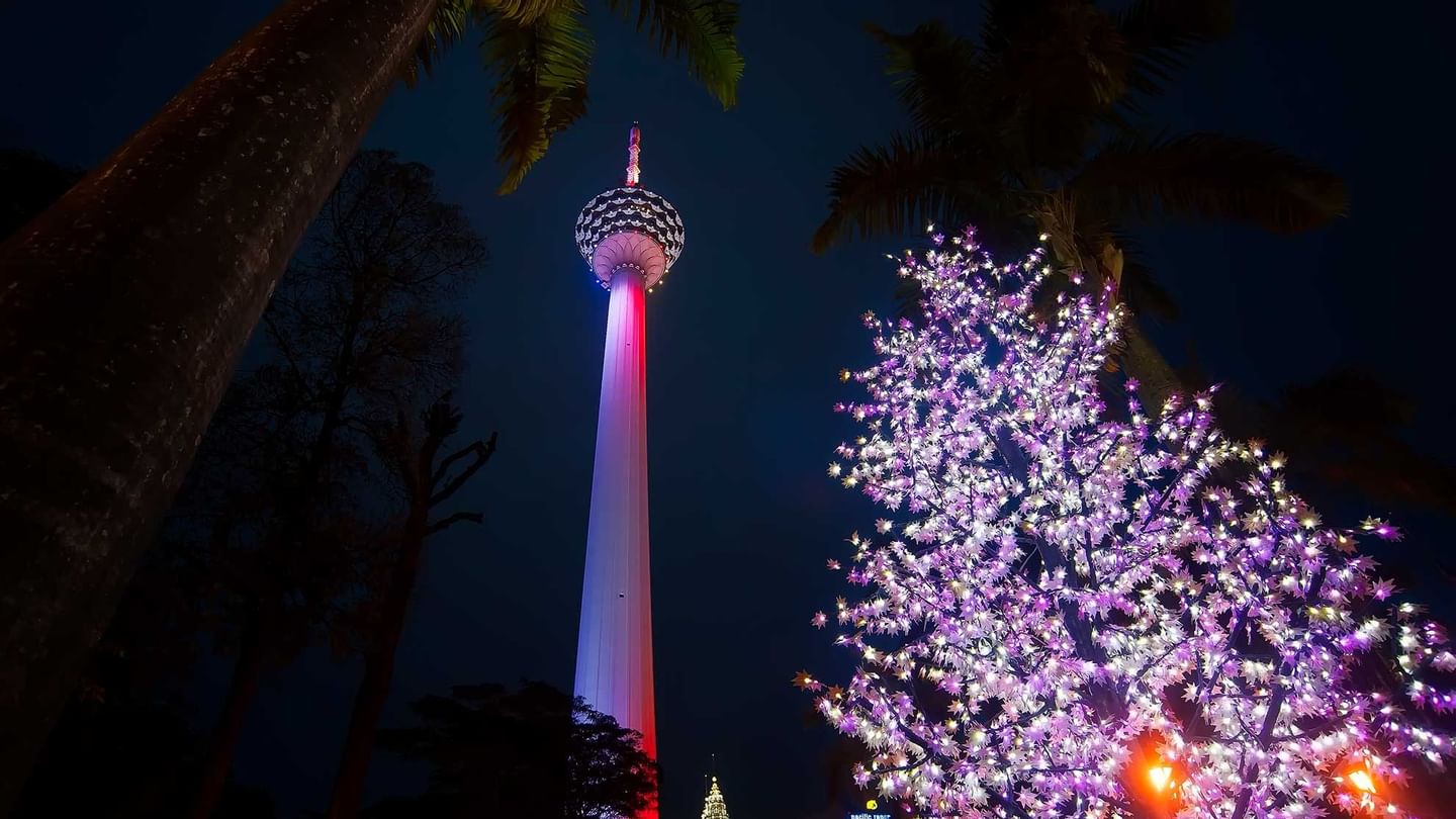 low-angle view of Kuala Lumpur Tower at nighttime near Sunway Velocity Hotel