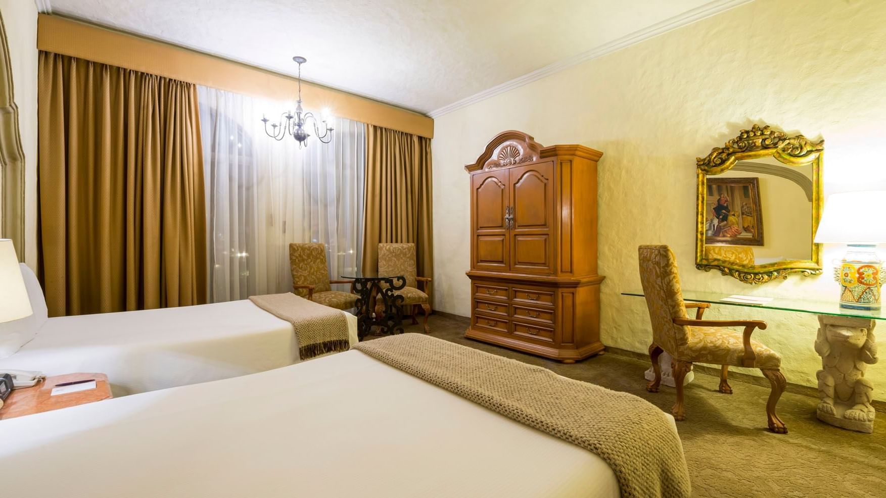 2 Double Master Suite featuring twin beds and a tall carved wood wardrobe at Quinta Real Aguascalientes