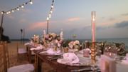 Dining table arrangement with floral decor on the beach at Diplomat Beach Resort