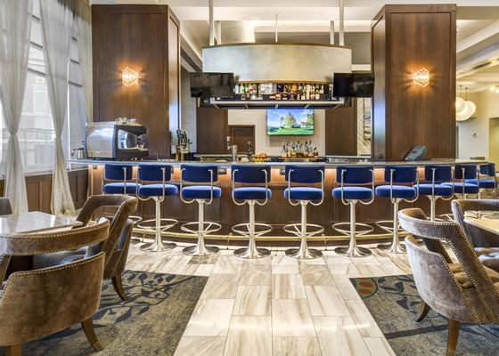 a row of barstools at a bar