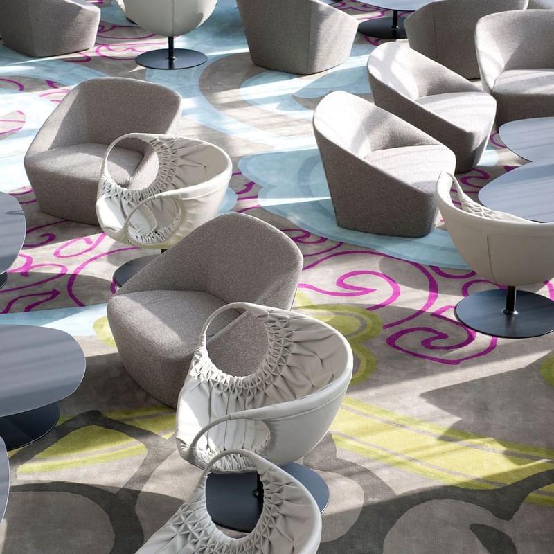 Sofa chairs in a lounge area at Crown Metropol Melbourne