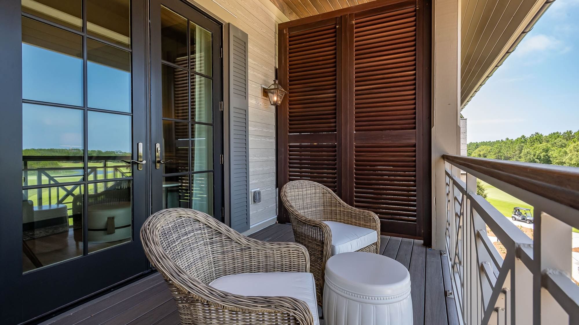 Balcony lounge area overlooking the land in Golf View King Room With Balcony at Camp Creek Inn