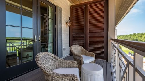Balcony lounge area overlooking the land in Golf View King Room With Balcony at Camp Creek Inn