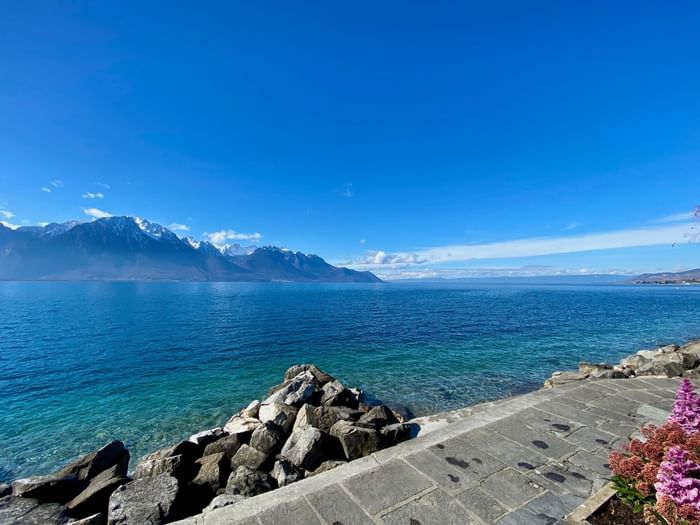 Lake Geneva with a backdrop of rugged mountains near Starling Hotel Lausanne