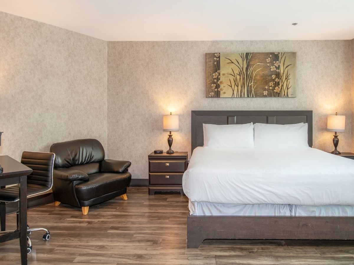 Coast Accessible King room with a king bed, chair, and desk at Coast Lonsdale Quay Hotel