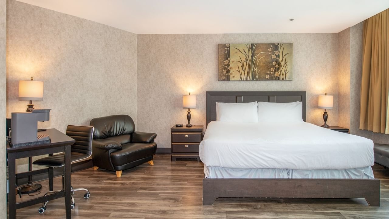 Coast Accessible King room with a king bed, chair, and desk at Coast Lonsdale Quay Hotel