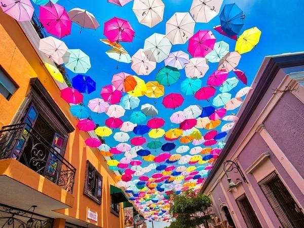 Street decorated with umbrellas near Grand Fiesta Americana
