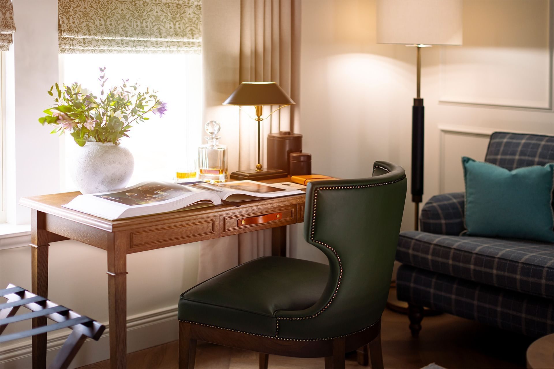 Work desk with comfy chair, open book and lamp in Courtyard Suite, Portrush accommodation at Dunluce Lodge