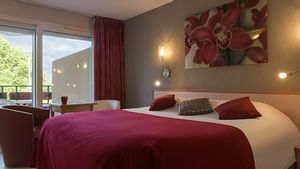 Large double bed in Superior Double Room at Hotel L'Arc-En-Ciel