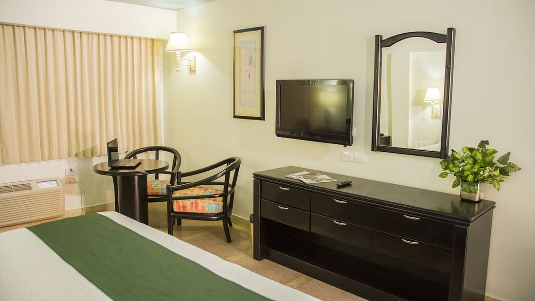 TV station, desk & mirror in Executive Room at Gamma Hotels