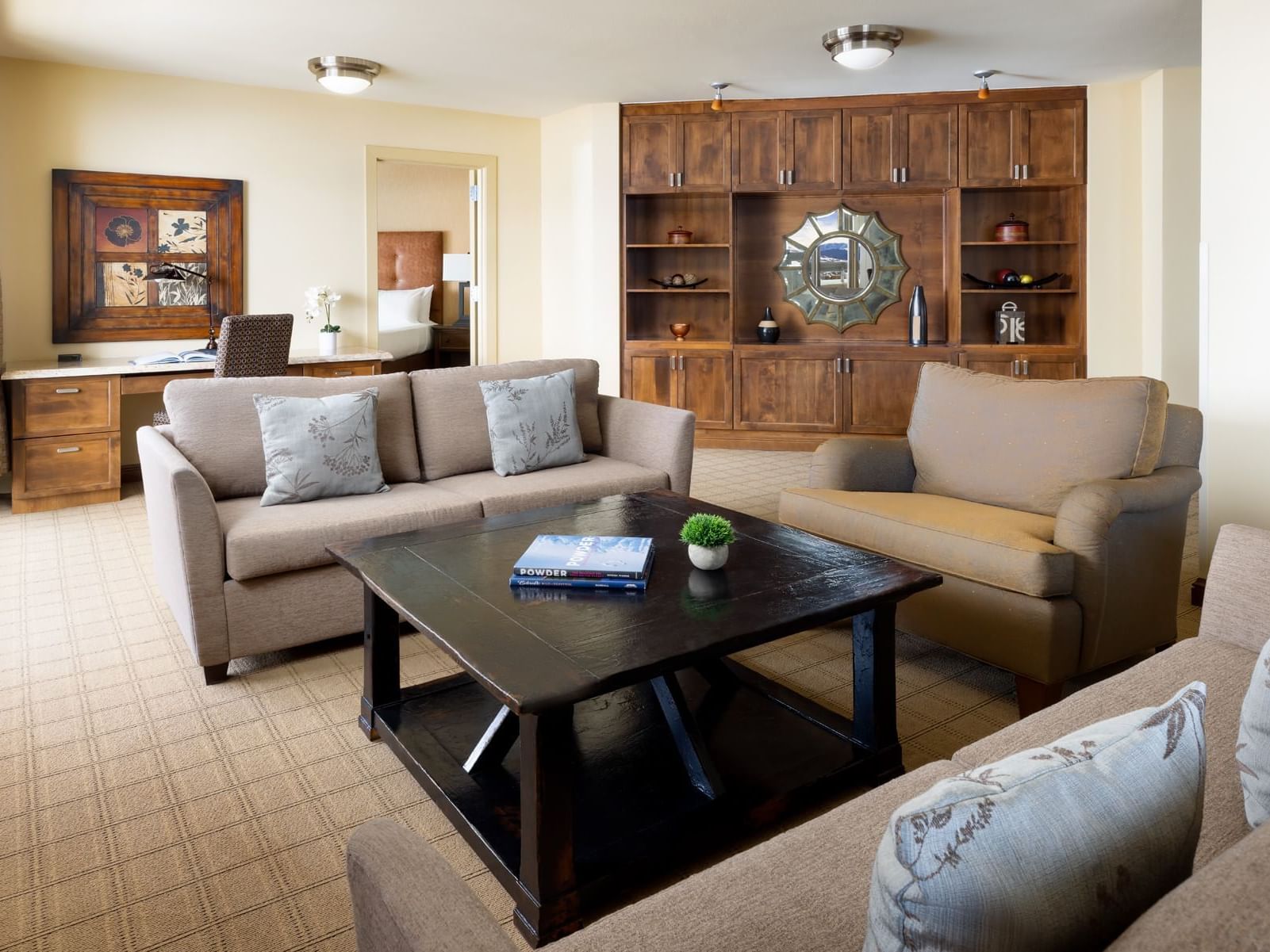 Living room of the Presidential Suite at the Elevation Resort and Spa with sofa, armchair, and coffee table.