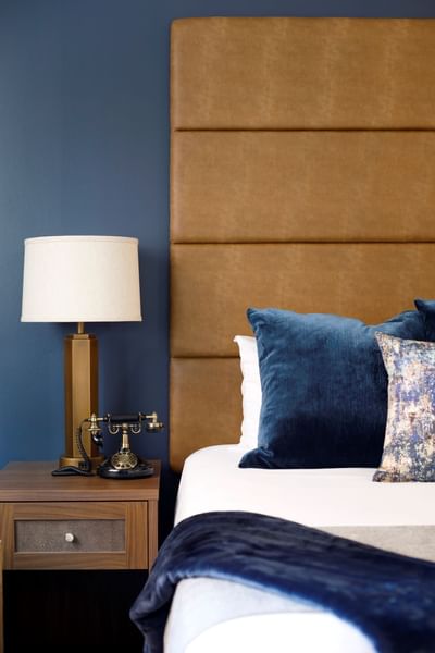 Queen bed and side table at Hotel at Old Town