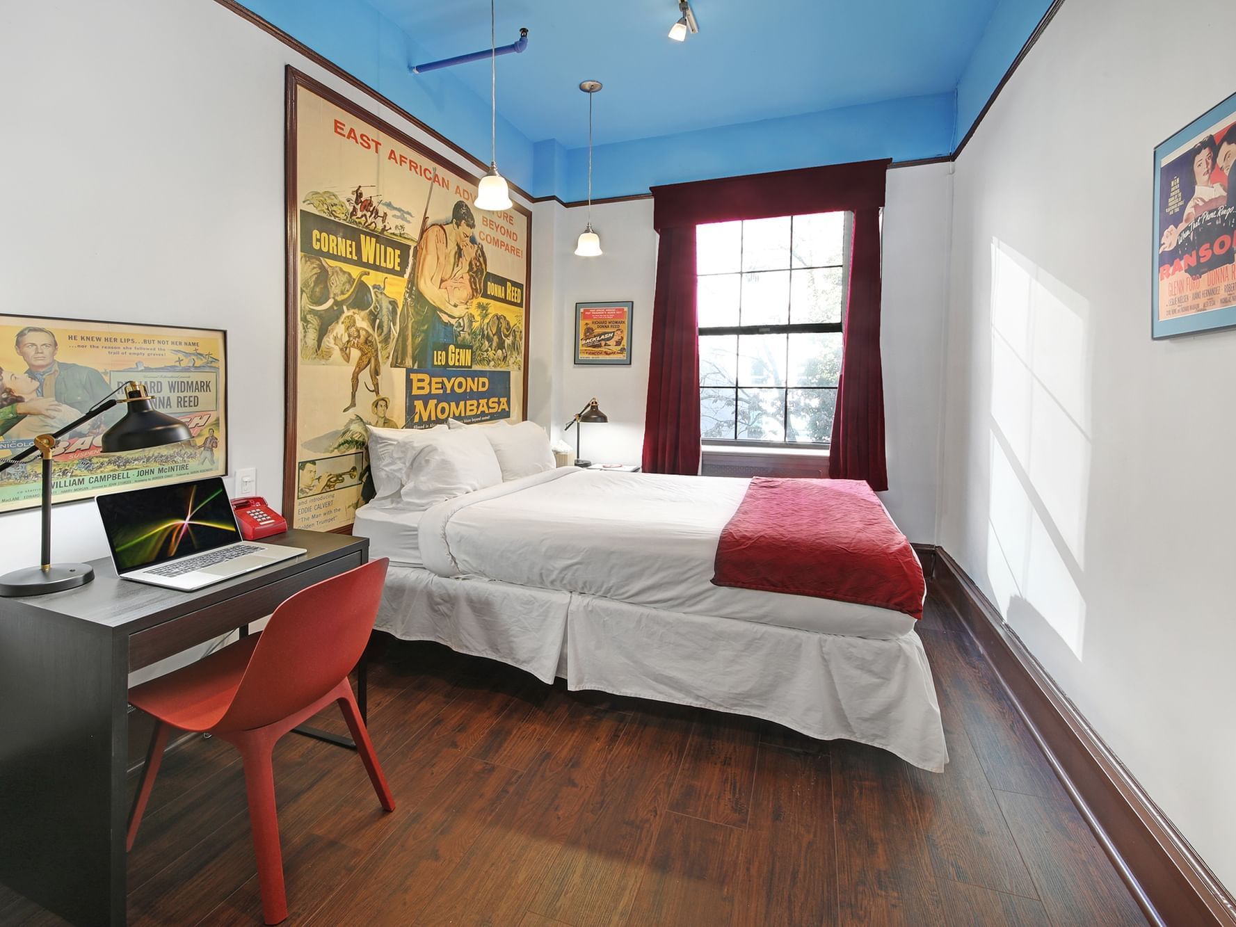 Standard Room at Chelsea Pines Inn in New York with desk and large bed.