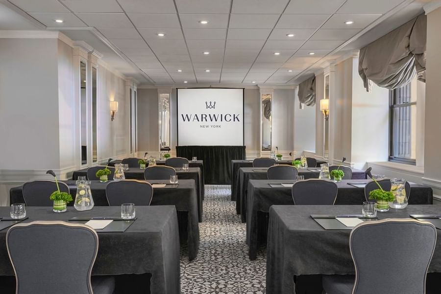 Classroom table set-up facing large screen in Sussex Meeting Room at Warwick New York