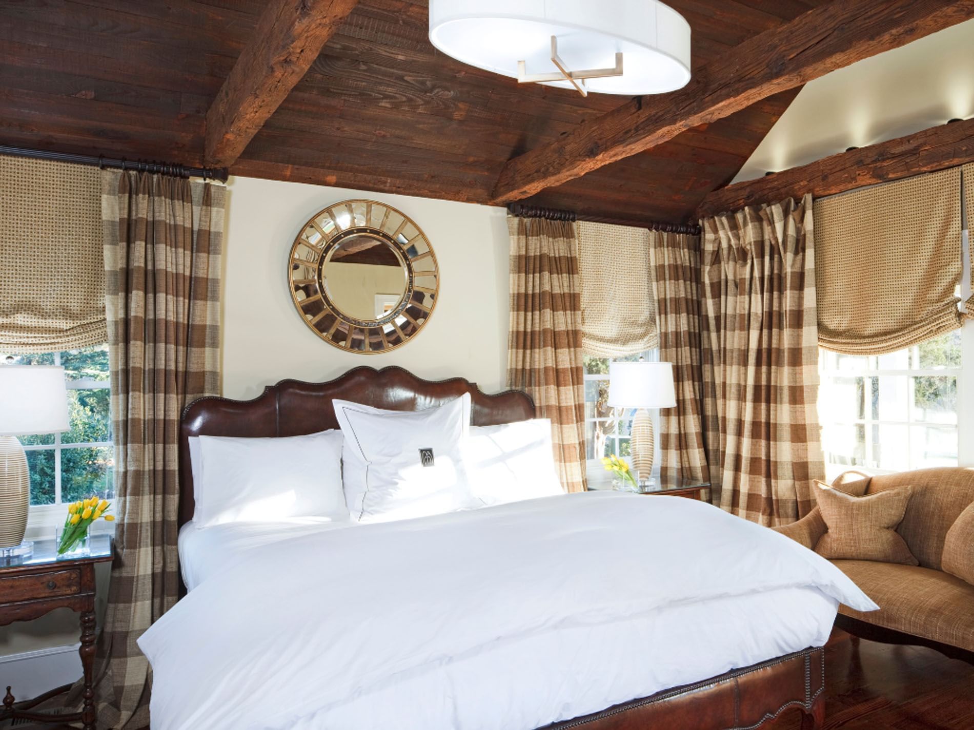 The Weaver's Cottage room with cozy bed and checkered curtains Hotels in the inn at willow grove