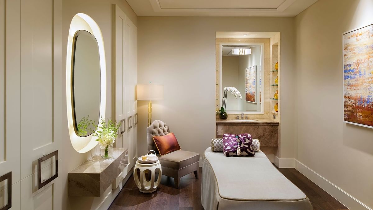 Crown Spa Standard Room with mirrors and mini table by the bench seating at Crown Hotels Melbourne