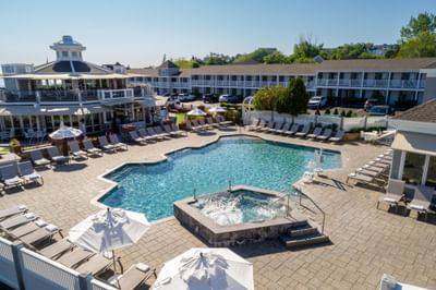 Elevated view of the outdoor swimming pool, hot tub, and lounge area at Anchorage By The Sea